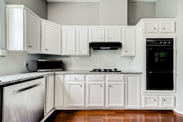 kitchen featuring black appliances, light stone counters, white cabinetry, and dark wood-type flooring