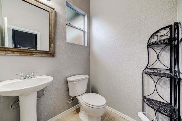 bathroom featuring tile patterned flooring and toilet