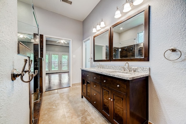 bathroom with tile patterned flooring, vanity, and a shower with shower door