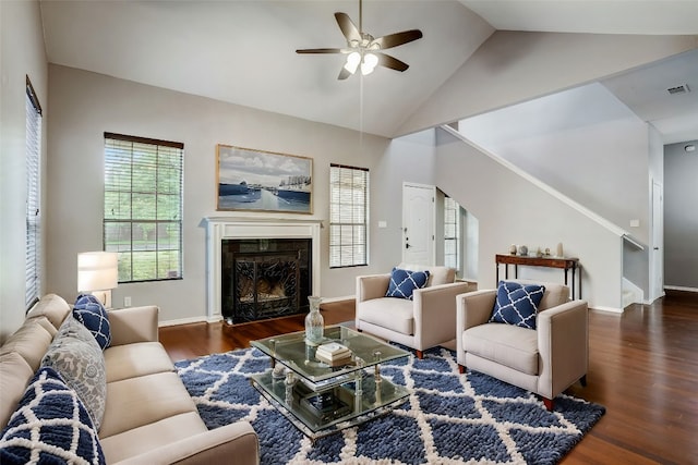 living room with lofted ceiling, ceiling fan, dark hardwood / wood-style floors, and a high end fireplace