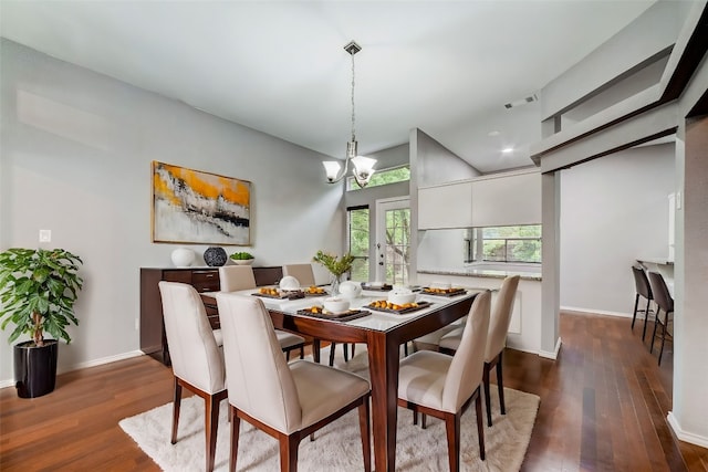 dining space featuring dark hardwood / wood-style flooring and a notable chandelier