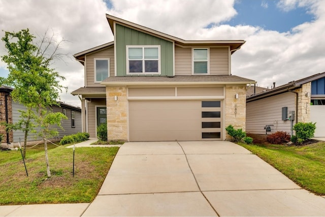 view of front of property featuring a garage and a front lawn