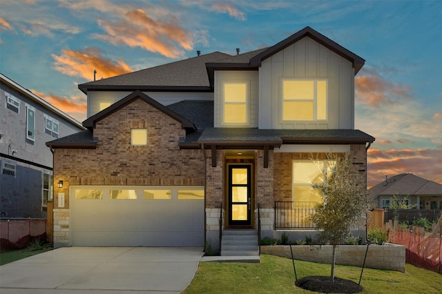 view of front facade with a garage and a yard