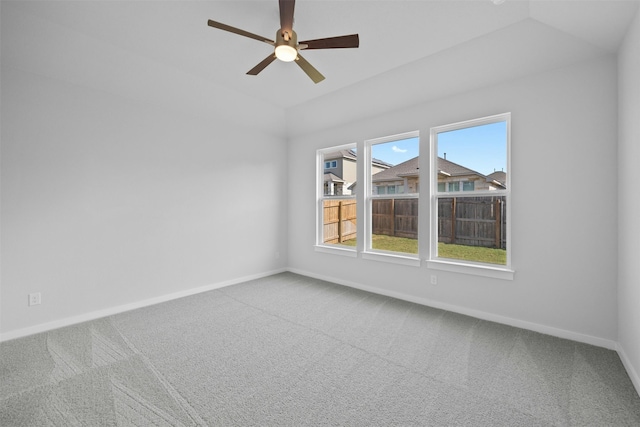 carpeted spare room featuring ceiling fan and lofted ceiling