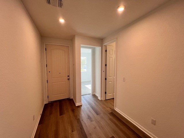 hallway with dark hardwood / wood-style floors