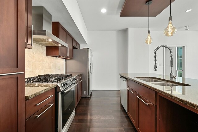 kitchen featuring light stone counters, sink, wall chimney range hood, appliances with stainless steel finishes, and dark hardwood / wood-style flooring