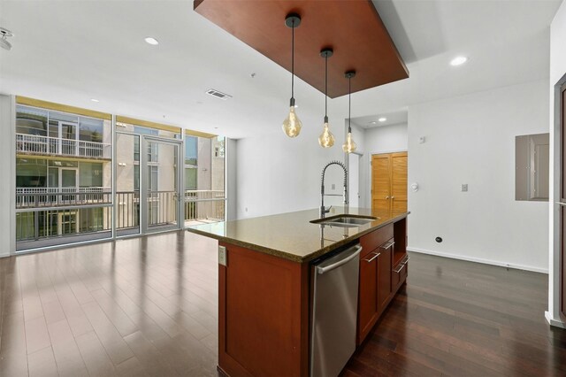 kitchen with dark hardwood / wood-style floors, sink, hanging light fixtures, a center island with sink, and stainless steel dishwasher