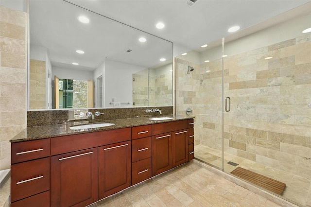 bathroom featuring vanity, tile walls, and a shower with shower door