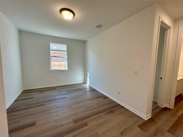 empty room with wood-type flooring