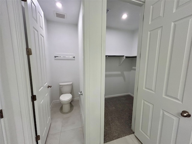 bathroom featuring toilet and tile patterned floors