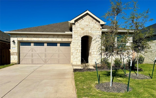 view of front of home with a front lawn and a garage