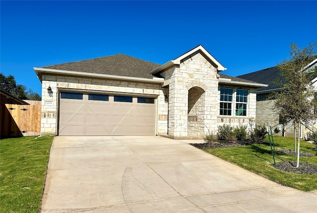 view of front of property featuring a front yard and a garage