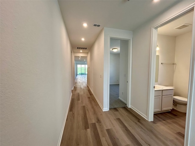 hall with light hardwood / wood-style flooring