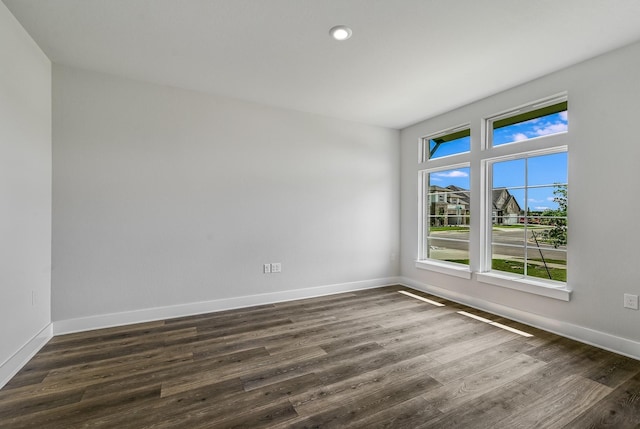 spare room with dark hardwood / wood-style floors