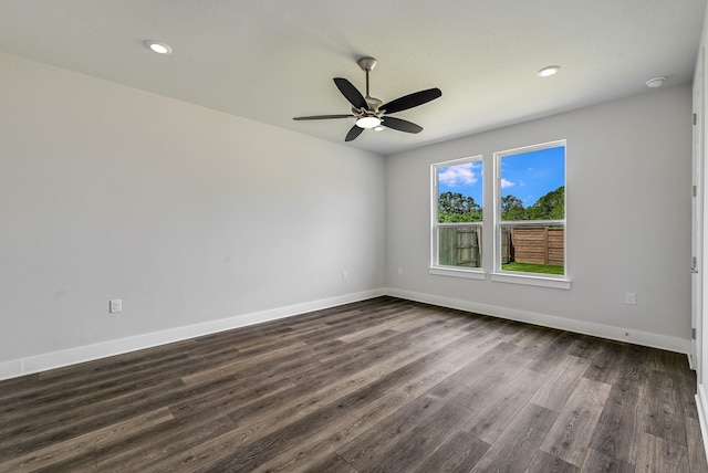 spare room with ceiling fan and dark hardwood / wood-style floors