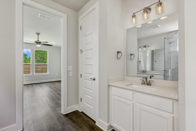 bathroom with ceiling fan, walk in shower, vanity, and hardwood / wood-style flooring