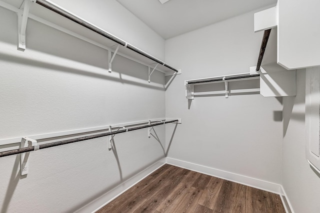 spacious closet featuring dark hardwood / wood-style floors