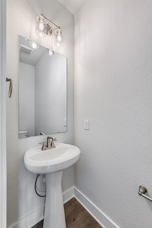 bathroom with wood-type flooring