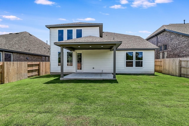 back of property with a patio and a yard