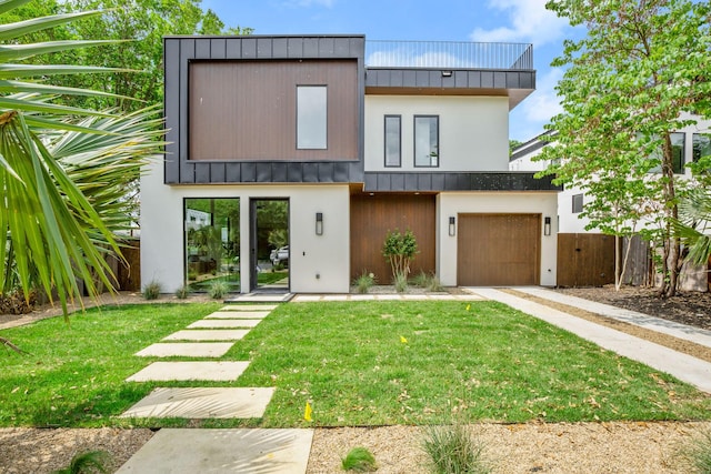 view of front of house with a garage and a front yard