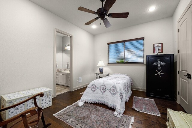 bedroom with ceiling fan, recessed lighting, dark wood-type flooring, baseboards, and ensuite bath