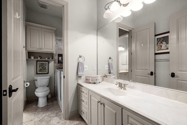 bathroom with toilet, visible vents, and vanity