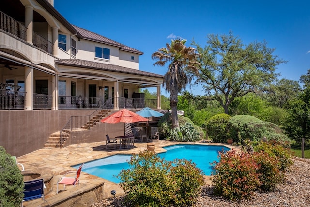 pool with stairway and a patio area