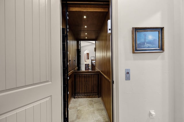 hallway featuring arched walkways, recessed lighting, and elevator