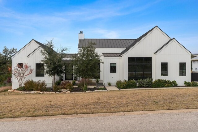 modern inspired farmhouse with a front yard