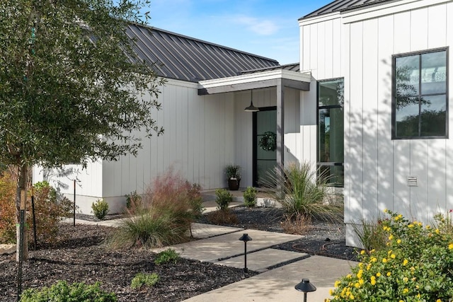 view of exterior entry with metal roof