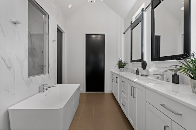 bathroom with tile patterned flooring, vanity, independent shower and bath, and vaulted ceiling