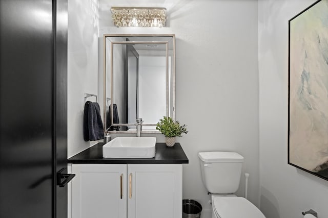 bathroom featuring toilet and vanity