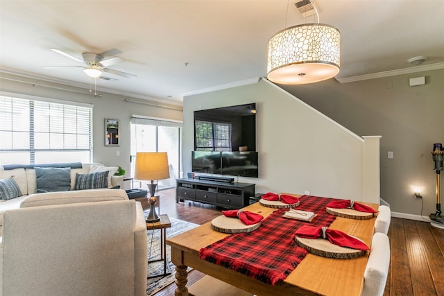 living room with ceiling fan, crown molding, and dark wood-type flooring