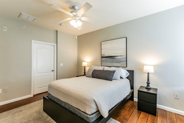 bedroom with ceiling fan and dark wood-type flooring