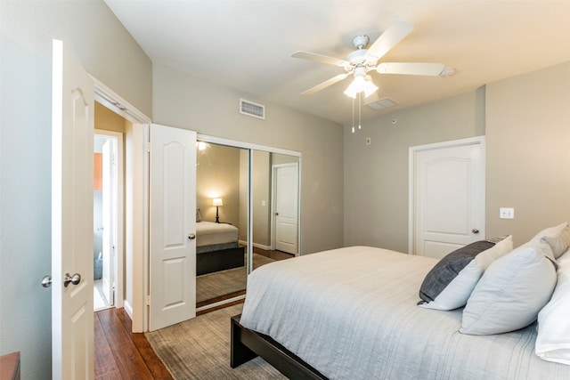 bedroom featuring a closet, dark wood-type flooring, and ceiling fan