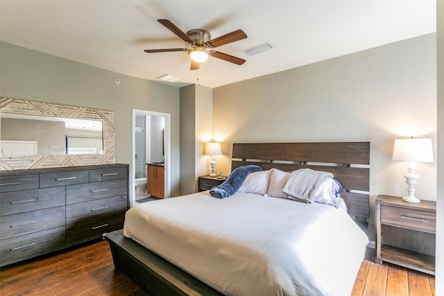 bedroom with ceiling fan, ensuite bathroom, and dark hardwood / wood-style floors