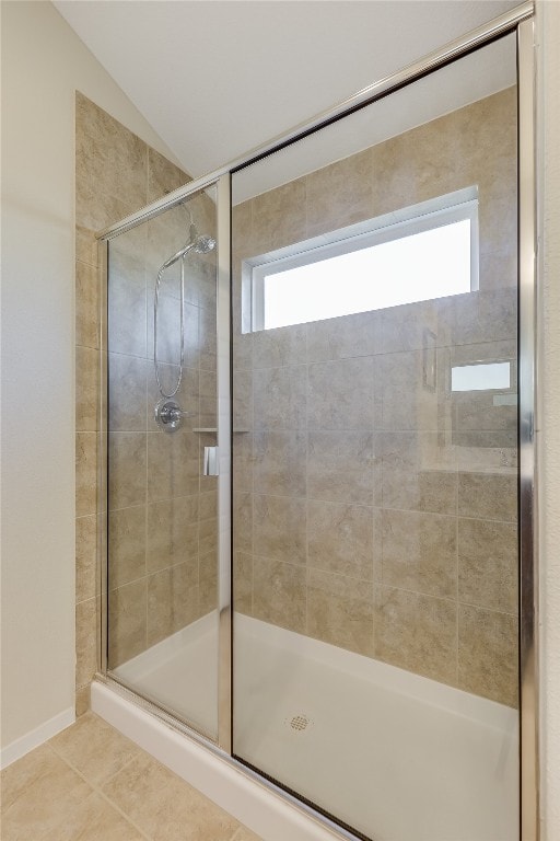 bathroom featuring tile patterned flooring, an enclosed shower, and lofted ceiling