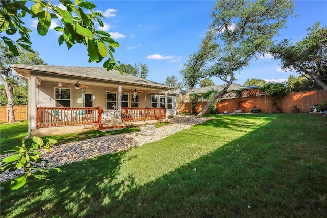 back of house with a lawn, a wooden deck, and ceiling fan