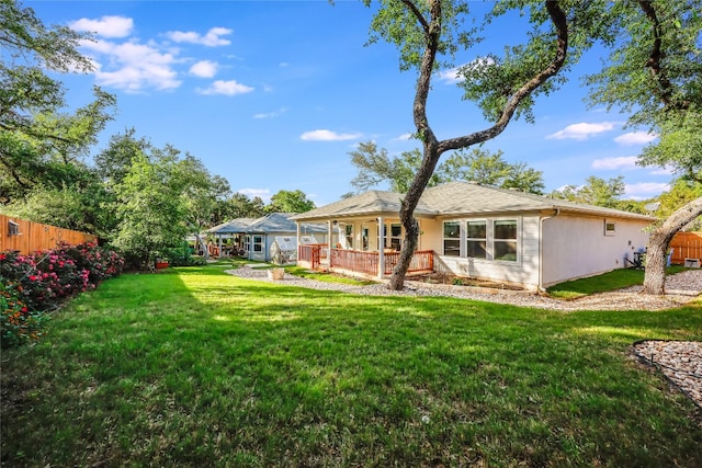 rear view of house with a yard