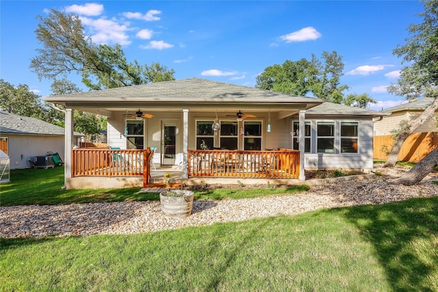 rear view of house featuring a porch, a yard, ceiling fan, and central air condition unit