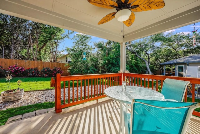 wooden terrace with a yard and ceiling fan