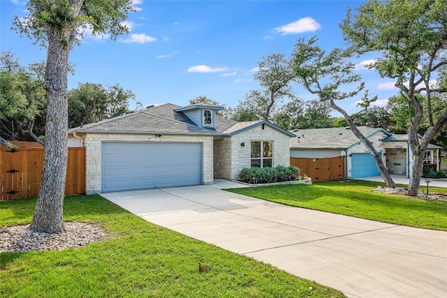 ranch-style home featuring a garage and a front yard