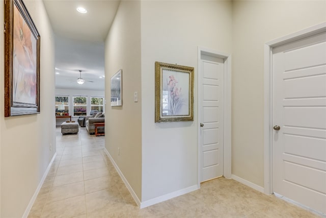 hall with light tile patterned floors