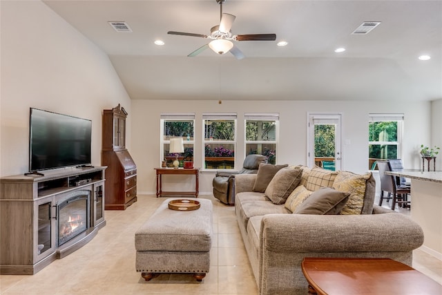 tiled living room with ceiling fan and lofted ceiling