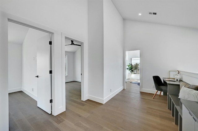 office area featuring a high ceiling, plenty of natural light, and light hardwood / wood-style flooring