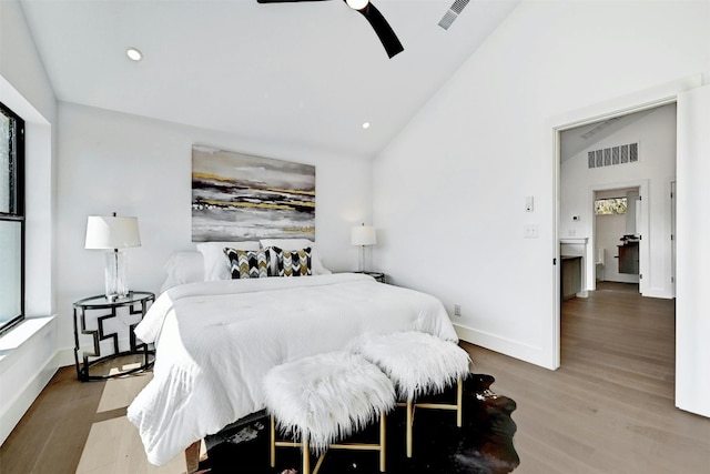 bedroom with hardwood / wood-style flooring, vaulted ceiling, and ceiling fan