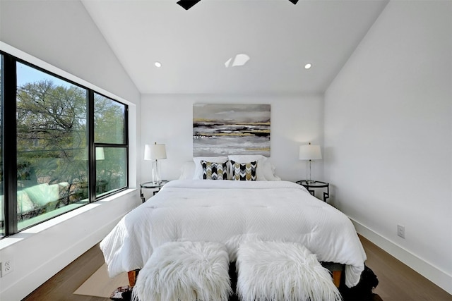 bedroom with hardwood / wood-style flooring, vaulted ceiling, and ceiling fan