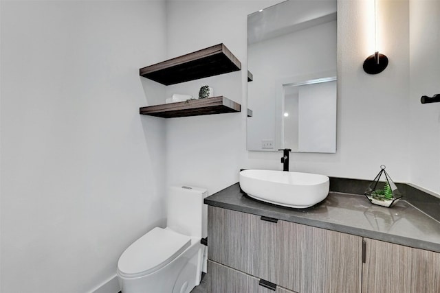 bathroom featuring vanity and toilet