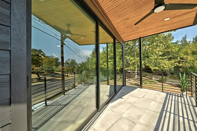 sunroom / solarium featuring plenty of natural light and ceiling fan