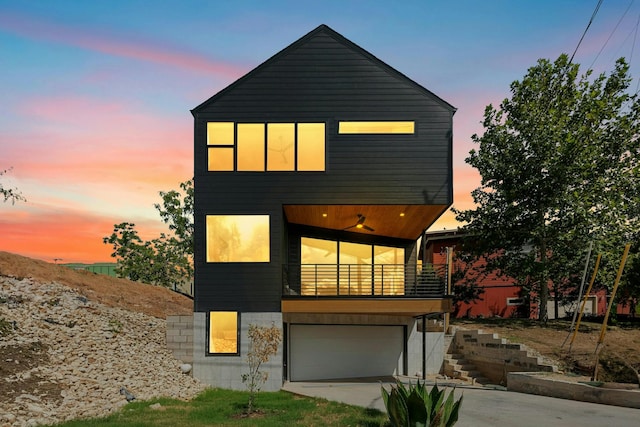 view of front of property featuring a garage and a balcony